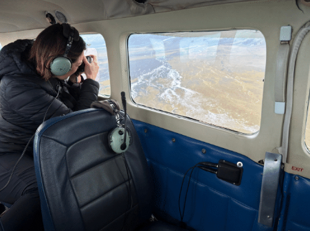 Photographer Emma Willets capturing scenes of Icelands braided rivers our a window of a fixed wing Cessna plane