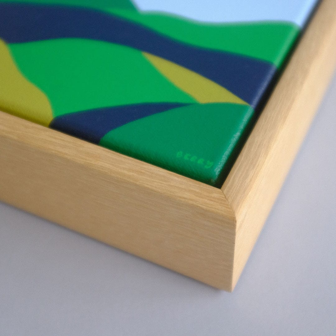 Close up of an abstract painting by Alice Berry in a wooden frame.