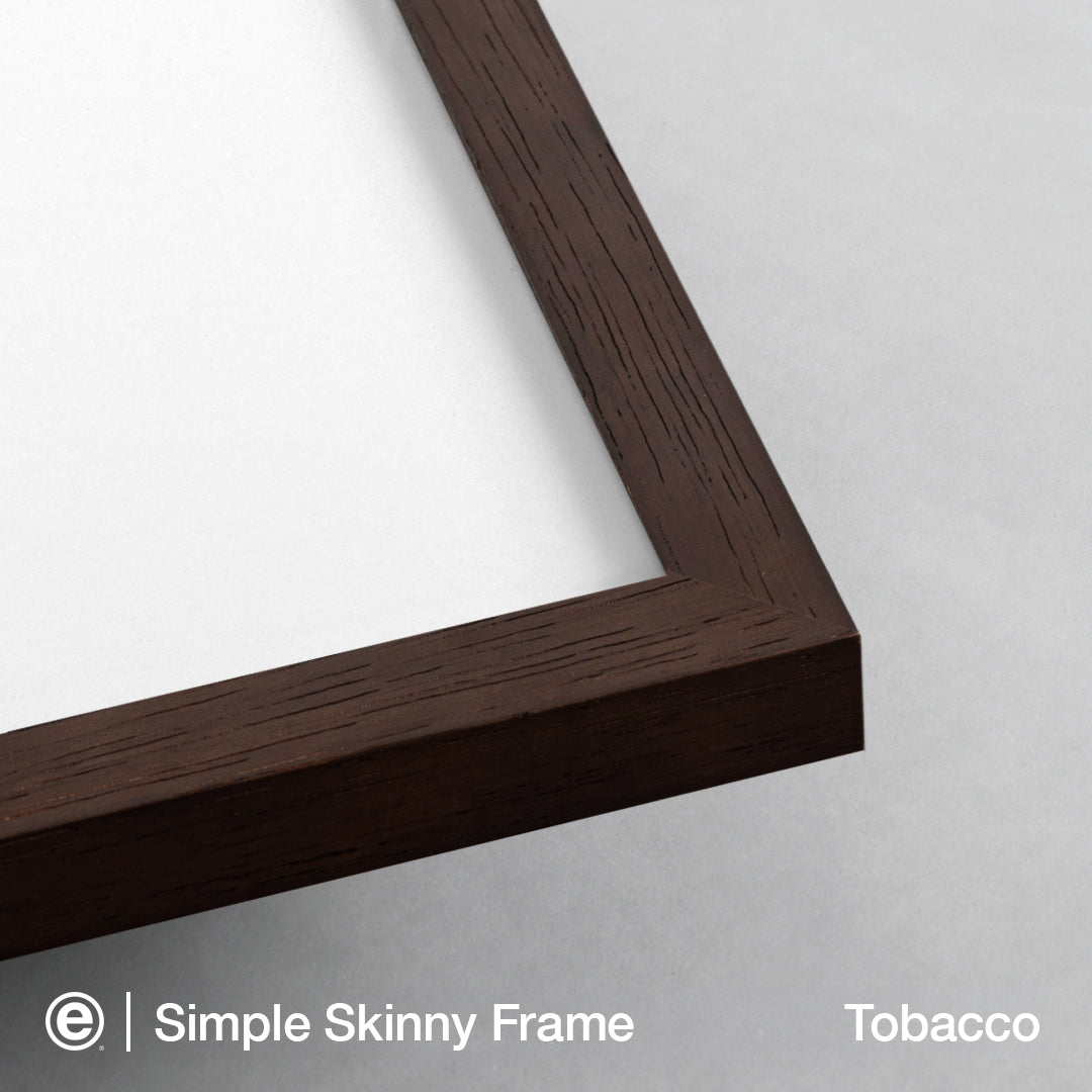 Close-up of a dark brown wooden picture frame corner on a light gray background, with text at the bottom reading 'Simple Skinny Frame' and 'Tobacco'.